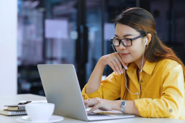 Woman in 40s with a laptop looking into studies again